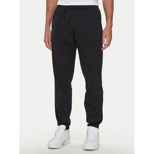 adidas Spodnie dresowe Trefoil Essentials IW5805 Czarny Regular Fit ze sklepu MODIVO w kategorii Spodnie męskie - zdjęcie 183639580
