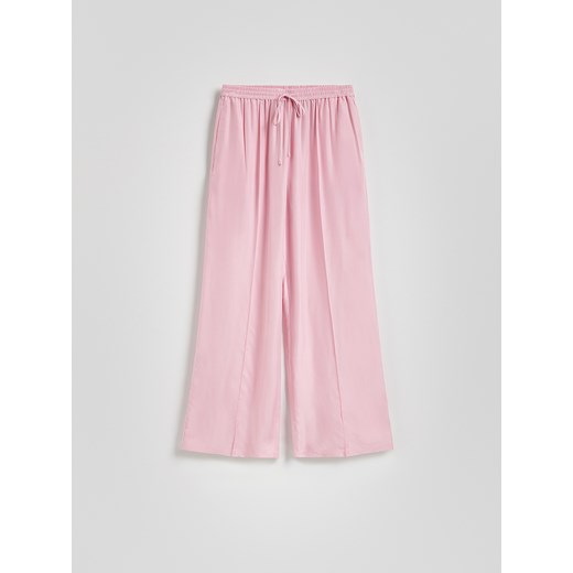 Reserved - Spodnie z tkaniną cupro - pastelowy róż Reserved XS Reserved