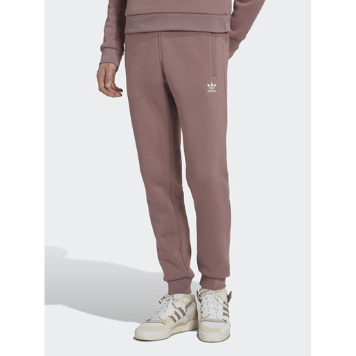 adidas Spodnie dresowe adicolor Essentials Trefoil HK0105 Różowy Slim Fit ze sklepu MODIVO w kategorii Spodnie damskie - zdjęcie 183945474
