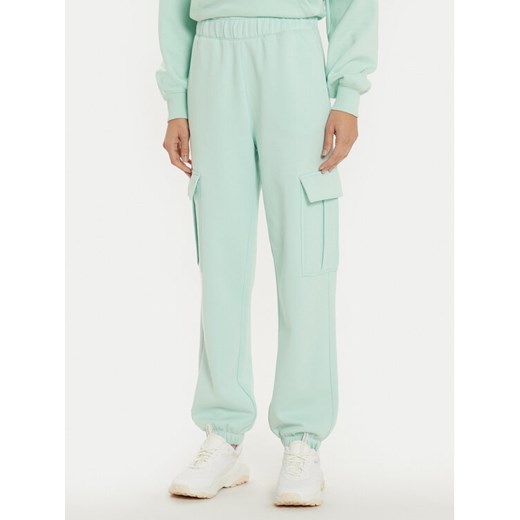 Champion Spodnie dresowe 117554 Zielony Loose Fit ze sklepu MODIVO w kategorii Spodnie damskie - zdjęcie 183948724