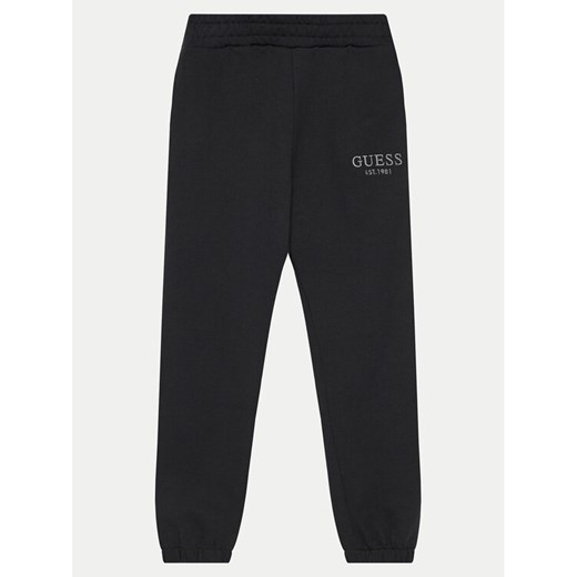 Guess Spodnie dresowe L4BQ15 KAV33 Czarny Regular Fit ze sklepu MODIVO w kategorii Spodnie chłopięce - zdjęcie 183985830