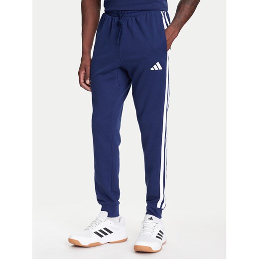 adidas Spodnie dresowe Essential 3-Stripes JD1878 Niebieski Regular Fit ze sklepu MODIVO w kategorii Spodnie męskie - zdjęcie 184019230