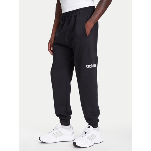 adidas Spodnie dresowe Essentials Linear Fleece JN1786 Czarny Regular Fit ze sklepu MODIVO w kategorii Spodnie męskie - zdjęcie 184019430