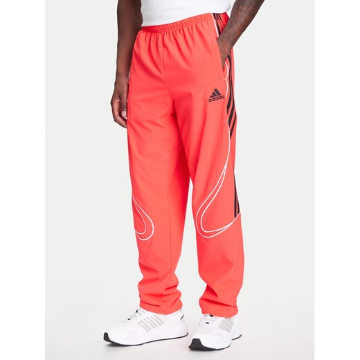 adidas Spodnie dresowe Teamgeist adicolor JW5871 Czerwony Loose Fit ze sklepu MODIVO w kategorii Spodnie męskie - zdjęcie 184045680