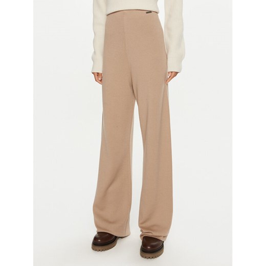Calvin Klein Spodnie dresowe K20K207680 Beżowy Relaxed Fit ze sklepu MODIVO w kategorii Spodnie damskie - zdjęcie 184058061