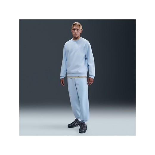 Męskie spodnie z dzianiny ze ściągaczami Nike Solo Swoosh - Niebieski ze sklepu Nike poland w kategorii Spodnie męskie - zdjęcie 184264272