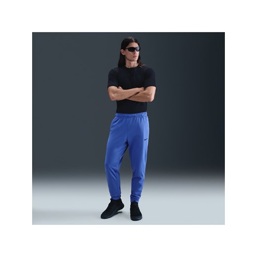 Męskie zwężane spodnie do fitnessu Therma-FIT Nike Therma - Niebieski ze sklepu Nike poland w kategorii Spodnie męskie - zdjęcie 184264481