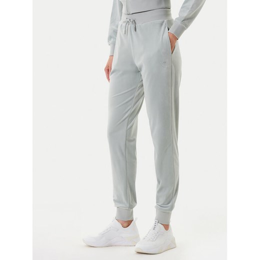 Guess Spodnie dresowe V3BB27 K0232 Zielony Regular Fit ze sklepu MODIVO w kategorii Spodnie damskie - zdjęcie 184286524