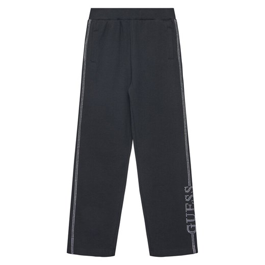 Guess Spodnie dresowe J5YQ12 KA6R4 Czarny Regular Fit ze sklepu MODIVO w kategorii Spodnie chłopięce - zdjęcie 184575294