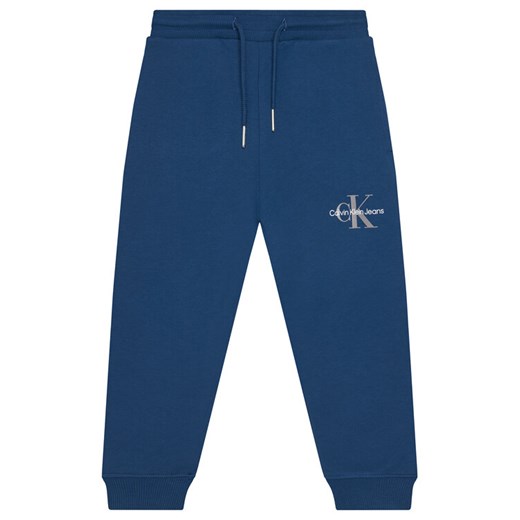 Calvin Klein Jeans Spodnie dresowe Monogram Logo IU0IU00285 M Niebieski Regular Fit ze sklepu MODIVO w kategorii Spodnie chłopięce - zdjęcie 184613241