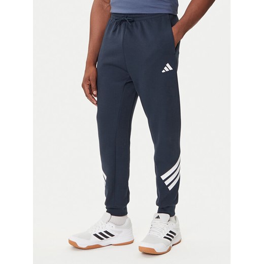 adidas Spodnie dresowe Future Icons 3-Stripes JW7088 Granatowy Regular Fit ze sklepu MODIVO w kategorii Spodnie męskie - zdjęcie 184672713