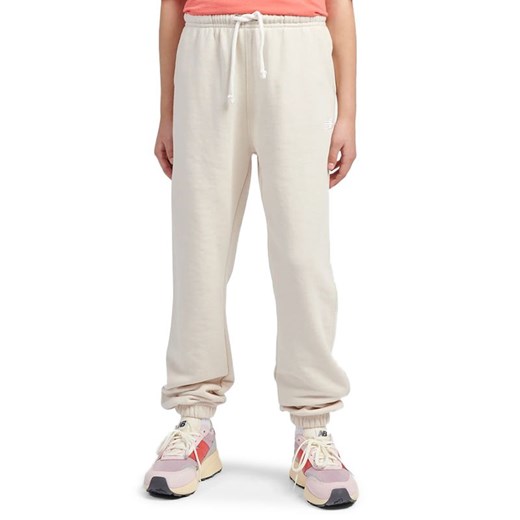 Spodnie dziecięce New Balance LAKG0058LIN - beżowe ze sklepu streetstyle24.pl w kategorii Spodnie dziewczęce - zdjęcie 184789984