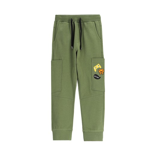 Coccodrillo Spodnie dresowe WC5120105GBK Zielony Slim Fit ze sklepu MODIVO w kategorii Spodnie chłopięce - zdjęcie 185525593