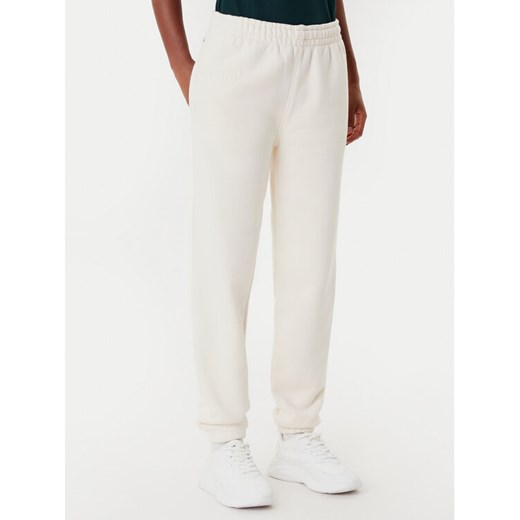 Lacoste Spodnie dresowe XF0353 Beżowy Regular Fit ze sklepu MODIVO w kategorii Spodnie damskie - zdjęcie 185634852