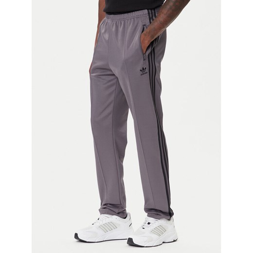 adidas Spodnie dresowe adicolor Classics Beckenbauer JY1274 Szary Slim Fit ze sklepu MODIVO w kategorii Spodnie męskie - zdjęcie 185741453