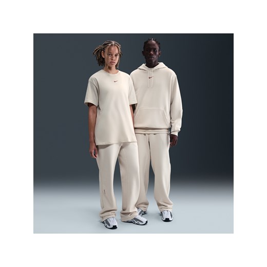 Spodnie dresowe o luźnym kroju u dołu Fleece CS NOCTA - Brązowy ze sklepu Nike poland w kategorii Spodnie męskie - zdjęcie 185994711