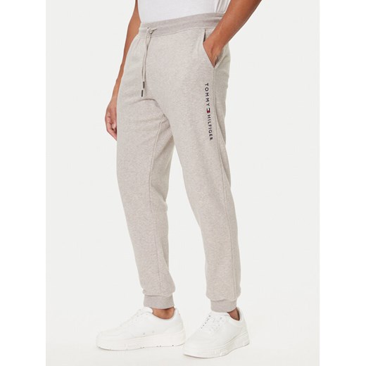 Tommy Hilfiger Spodnie dresowe UM0UM03664 Beżowy Regular Fit ze sklepu MODIVO w kategorii Spodnie męskie - zdjęcie 186028581