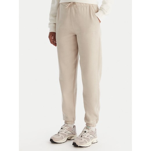 Reebok Spodnie dresowe Reebok X Ewa Chodakowska Evren RK25308CCW Beżowy Regular Fit ze sklepu MODIVO w kategorii Spodnie damskie - zdjęcie 186818252