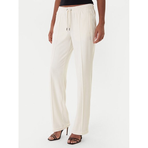 Juicy Couture Spodnie dresowe Tina JCWBJ225307 Beżowy Regular Fit ze sklepu MODIVO w kategorii Spodnie damskie - zdjęcie 187343354