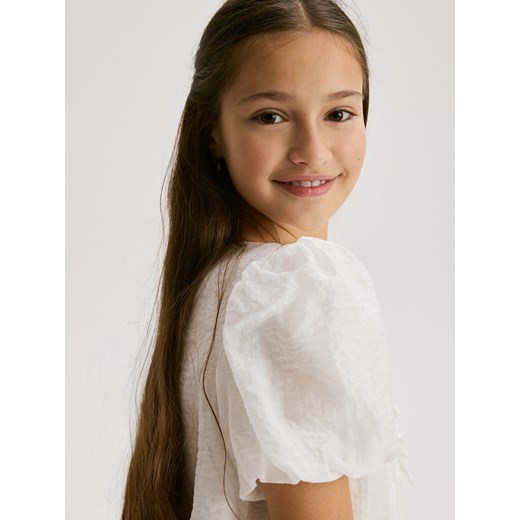 Reserved - Bluzka z kokardkami - złamana biel ze sklepu Reserved w kategorii Bluzki dziewczęce - zdjęcie 187474024
