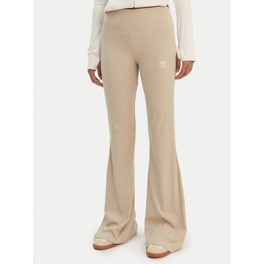 adidas Legginsy Essentials KD3850 Beżowy Flared Leg ze sklepu MODIVO w kategorii Spodnie damskie - zdjęcie 187803122