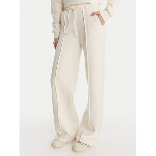 Guess Spodnie dresowe V6RB17 K9V31 Écru Regular Fit ze sklepu MODIVO w kategorii Spodnie damskie - zdjęcie 187964452