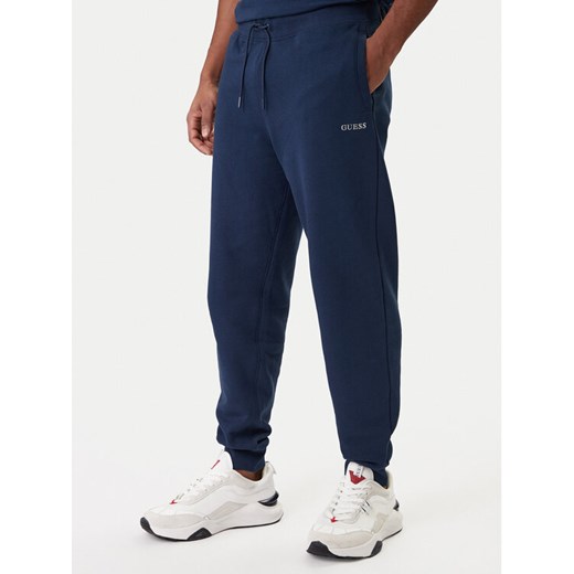 Guess Spodnie dresowe Z6RB12 KAIJ1 Granatowy Regular Fit ze sklepu MODIVO w kategorii Spodnie męskie - zdjęcie 188007764