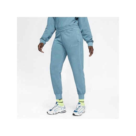 Spodnie damskie niebieskie Nike w sportowym stylu 