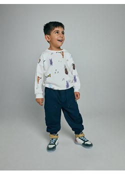 Reserved - Ocieplane spodnie z naszywką - granatowy ze sklepu Reserved w kategorii Spodnie chłopięce - zdjęcie 147986300