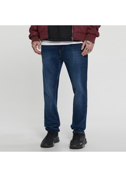 Cropp - Niebieskie jeansy slim - granatowy ze sklepu Cropp w kategorii Jeansy męskie - zdjęcie 151092692