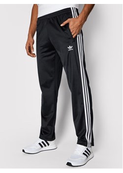 adidas Spodnie dresowe adicolor Firebird Tp GN3517 Czarny Regular Fit ze sklepu MODIVO w kategorii Spodnie męskie - zdjęcie 152588673