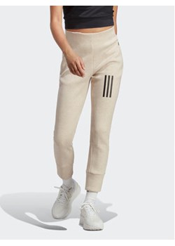 adidas Spodnie dresowe Mission Victory High-Waist 7/8 Tracksuit Bottoms IC0301 Brązowy Slim Fit ze sklepu MODIVO w kategorii Spodnie damskie - zdjęcie 152634011