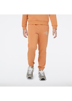 Spodnie dziecięce New Balance YP31508SEI – pomarańczowe ze sklepu New Balance Poland w kategorii Spodnie chłopięce - zdjęcie 153344393