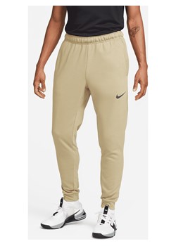 Męskie zwężane spodnie do fitnessu z dzianiny Dri-FIT Nike Dry - Brązowy ze sklepu Nike poland w kategorii Spodnie męskie - zdjęcie 161527242