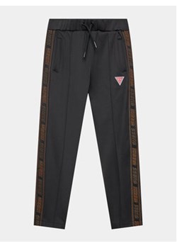 Guess Spodnie dresowe L3BQ16 KB212 Czarny Relaxed Fit ze sklepu MODIVO w kategorii Spodnie chłopięce - zdjęcie 162764581