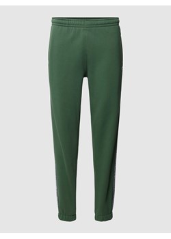 Spodnie dresowe z paskami z logo model ‘TAPE’ ze sklepu Peek&Cloppenburg  w kategorii Spodnie męskie - zdjęcie 168294692