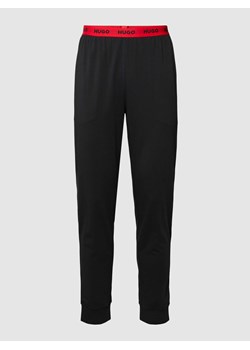 Spodnie dresowe z elastycznym pasem z logo model ‘Linked’ ze sklepu Peek&Cloppenburg  w kategorii Spodnie męskie - zdjęcie 168299151