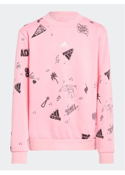 adidas Bluza Brand Love Allover Print IA1576 Różowy Loose Fit ze sklepu MODIVO w kategorii Bluzy dziewczęce - zdjęcie 168378521