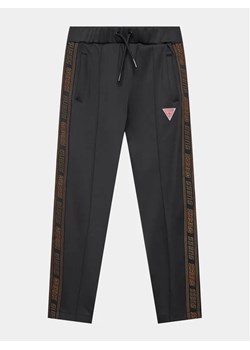 Guess Spodnie dresowe L3BQ16 KB212 Czarny Relaxed Fit ze sklepu MODIVO w kategorii Spodnie chłopięce - zdjęcie 168440582