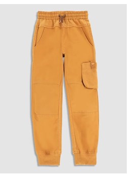 Coccodrillo Spodnie dresowe WC3119101DWK Żółty Slim Fit ze sklepu MODIVO w kategorii Spodnie dziewczęce - zdjęcie 168480071