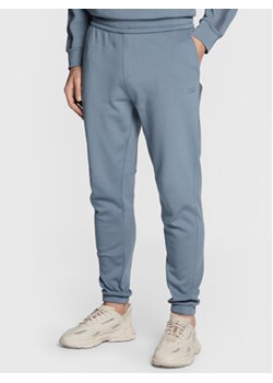 Calvin Klein Spodnie dresowe Logo Tape K10K110820 Szary Regular Fit ze sklepu MODIVO w kategorii Spodnie męskie - zdjęcie 168530412