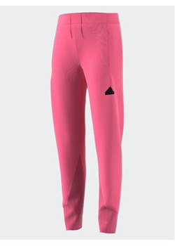 adidas Spodnie dresowe IK5714 Różowy Regular Fit ze sklepu MODIVO w kategorii Spodnie dziewczęce - zdjęcie 168536162