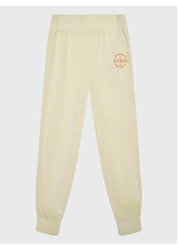 Guess Spodnie dresowe J2BQ12 KBEB0 Beżowy Regular Fit ze sklepu MODIVO w kategorii Spodnie chłopięce - zdjęcie 168538512