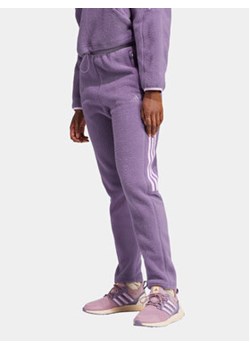 adidas Spodnie dresowe Tiro Fleece IJ8415 Fioletowy Regular Fit ze sklepu MODIVO w kategorii Spodnie męskie - zdjęcie 168552094