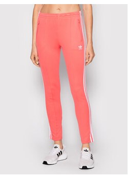 adidas Spodnie dresowe Primeblue Sst Track HF1994 Różowy Slim Fit ze sklepu MODIVO w kategorii Spodnie damskie - zdjęcie 168558734