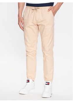 Tommy Jeans Joggery DM0DM16760 Beżowy Slim Fit ze sklepu MODIVO w kategorii Spodnie męskie - zdjęcie 168568050