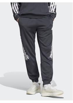 adidas Spodnie dresowe Future Icons Allover Print IB6127 Szary Regular Fit ze sklepu MODIVO w kategorii Spodnie męskie - zdjęcie 168583434
