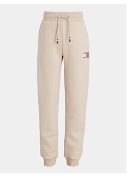Tommy Hilfiger Spodnie dresowe KB0KB08475 S Beżowy Regular Fit ze sklepu MODIVO w kategorii Spodnie chłopięce - zdjęcie 168605051