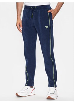 Guess Spodnie dresowe Z3YB03 KBC00 Granatowy Regular Fit ze sklepu MODIVO w kategorii Spodnie męskie - zdjęcie 168610613