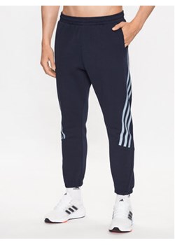 adidas Spodnie dresowe Future Icons 3-Stripes Joggers IJ6373 Niebieski Slim Fit ze sklepu MODIVO w kategorii Spodnie męskie - zdjęcie 168613912